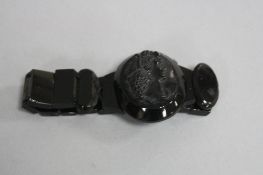 A VICTORIAN CARVED JET ELASTICATED BRACELET, with rectangular plaque links to a carved cameo