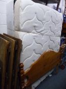 A 5' DIVAN BED, and mattress with drawers and a pine headboard