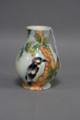A BOXED OLD TUPTON WARE VASE, tube lined decorated with Woodpecker and tree, height approximately