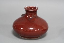 A MOORCROFT POTTERY SQUAT VASE, mottled red ground, height approximately 10cm