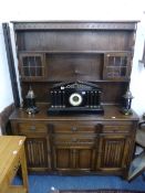 AN OAK CARVED AND LINENFOLD DRESSER