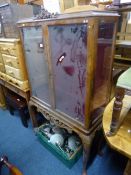 A WALNUT GLAZED TWO DOOR DISPLAY CABINET, and a modern side table with two drawers (sd) (key) (2)