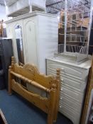 A MODERN CREAM TWO PIECE BEDROOM SUITE, comprising of a three door wardrobe and a chest of five long