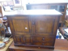 AN OAK TWO DOOR CUPBOARD, with smaller lower cupboard and two drawers