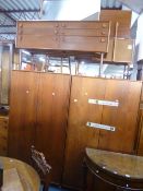 A TEAK FOUR PIECE BEDROOM SUITE, comprising two two door wardrobes, dressing table and a chest of