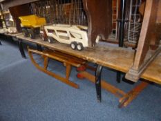 A VINTAGE WOODEN SLEDGE, a child's wooden scooter and two Tonka Toy trucks (4)