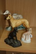 FOUR VARIOUS GREYHOUND/WHIPPET FIGURES, to include Beswick 'Jovial Roger' No.972,