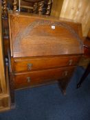 A CARVED OAK BUREAU, with two drawers