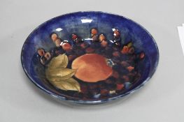 A MOORCROFT POTTERY SHALLOW BOWL, Pomegranate pattern on blue ground, impressed and painted marks,