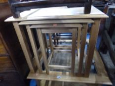 A MODERN LIGHT OAK NEST OF THREE TABLES