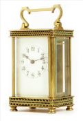 A carriage timepiece, cream enamel dial, cylinder platform, in a brass case with bands of beading,