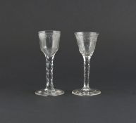 Two wine glasses, c.1770, the bowls cut with continuous floral garlands, raised on faceted stems,