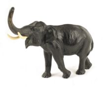 A late 19th century bronze model of an elephant, with bone tusks, 20.2cm long