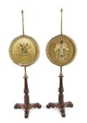 A pair of George IV mahogany pole fire-screens in the manner of Gillows, each with a brass pole with
