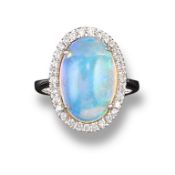 An opal and diamond cluster ring, the oval shaped crystal opal is set within a surround of round