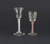 A Continental colour-twist wine glass, 18th century, with engraved bowl raised on a red and white