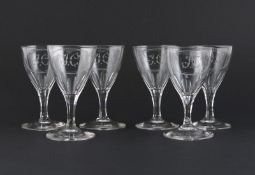 A set of six wine glasses, 19th century, raised on hexagonal faceted stems, the bowls engraved