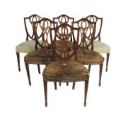 A set of six late 18th century mahogany shield back side chairs, four with original buttoned red