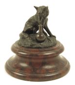 A late 19th century French bronze model of a fox with a vase, on a rouge marble plinth, 7.3cm high