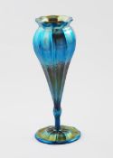 An Art Nouveau Louis Comfort Tiffany Favrile vase, footed, flaring slender form with everted, fluted