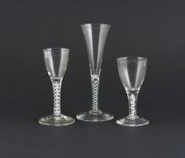 Three wine glasses, 18th century, two with funnel-shaped bowls, one a narrow drawn trumpet, all