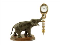 A mystery timepiece of elephant form, the movement with white enamel dial suspended from the spelter