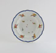 A Nantgarw soup plate, c.1818-20, of lobed form, the rim moulded with floral C scrolls, painted with