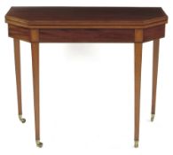 A George III mahogany tea table, inlaid stringing, the crossbanded canted top on twin gate supports,