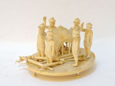 A carved Indian group, circa 1870, carved as figures holding aloft a howdah with seated figure