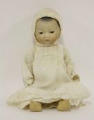 An Armand Marseille bisque head 'Oriental baby' doll, with open/close eyes, in original clothing,