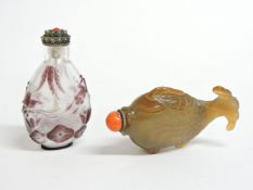 Two Chinese snuff bottles and stoppers, one cloudy glass moulded as a fish, and one overlaid in