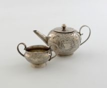 An 18th century miniature silver teapot and sugar bowl, unmarked, circular form, the teapot with a