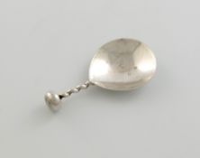 By A. E. Jones, a silver-caddy spoon, Birmingham 1924, the fig-shaped bowl with spot-hammered