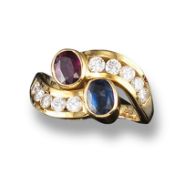 A ruby, sapphire and diamond cross-over ring, each shoulder set with five round brilliant cut