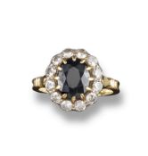 A sapphire and diamond cluster ring, the oval shaped sapphire is set within a surround of twelve