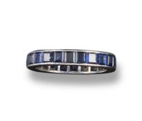 A full circle sapphire eternity ring, the calibrÃ© cut sapphires set in platinum. Size L 1/2..