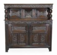 A Charles II oak press cupboard, circa 1670, rectangular top above a scroll and acanthus carved