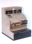 A National Shop’s till in pale-brown finish metal case, circa mid-20th century.