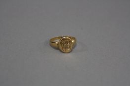 AN EARLY 20TH CENTURY 18CT GOLD POISON RING, oval hinged head engraved with fancy script entwinned