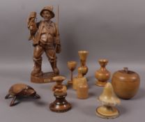 A carved wood figure of a fisherman together with various treen vases, canisters,