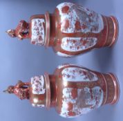 A pair of late 19th century Japanese vases and covers, the domed covers with Dog of Fo finial,