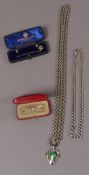 A silver Arts and Crafts enamel pendant (at fault) hung on a Victorian muff chain of nickel belcher
