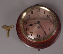Ships clock having a coppered bezel with black Arabic numerals, signed to the dial Langham and Sons,