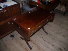 A reproduction mahogany and rosewood banded sofa table having four drawers to the apron and four