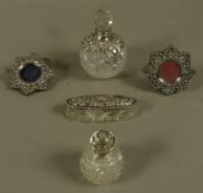 Two silver collared cut glass spherical perfume bottles,