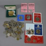 A tub of foreign coins and UK coins
