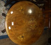 A Victorian walnut loo table the oval tilt top inlaid in satin and ebony with urns and scrolling