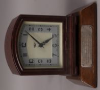 A 1940s brown Bakelite cased electric clock by Smiths together with a presentation plinth with