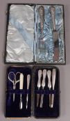 A silver handled manicure set in fitted case with later scissors together with a knife and fork