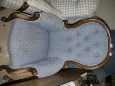 A Victorian mahogany framed armchair with button upholstery,